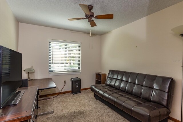 office area with a textured ceiling, carpet floors, and ceiling fan