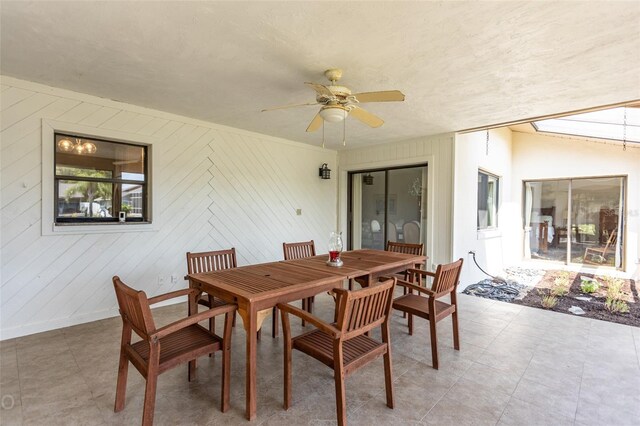 tiled dining space featuring ceiling fan