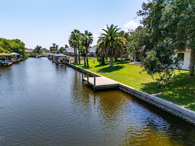 dock area with a water view and a lawn