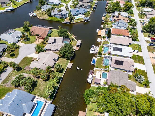 drone / aerial view with a water view and a residential view