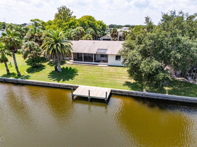 dock area featuring a lawn and a water view