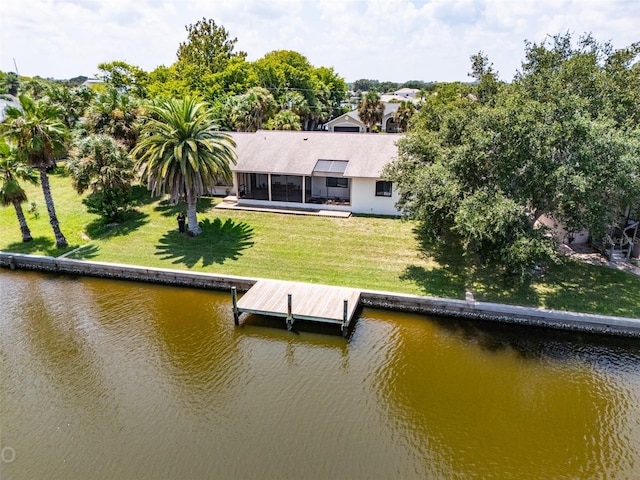 dock area with a water view and a yard