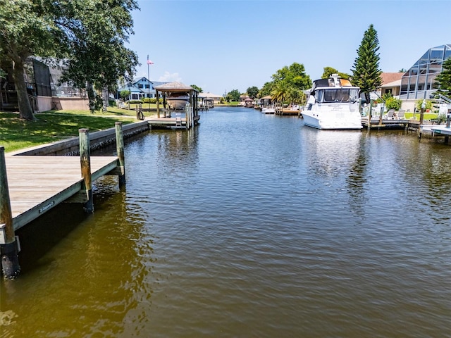 view of dock with a residential view and a water view