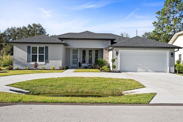 prairie-style home featuring a front yard and a garage