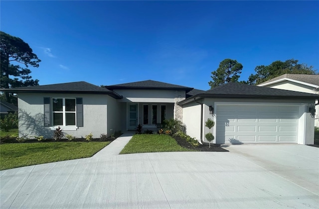 view of front of house featuring a garage and a front lawn