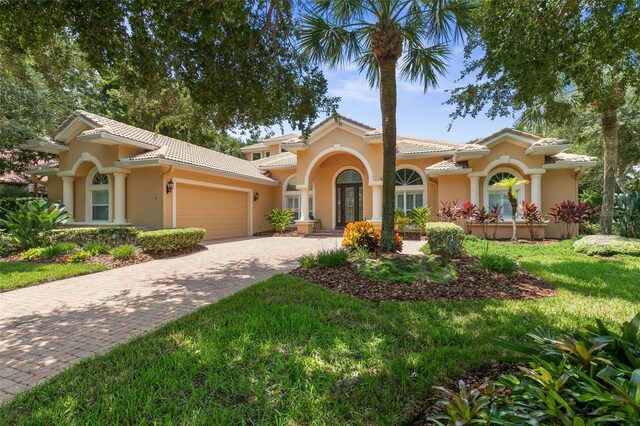 mediterranean / spanish-style home featuring a front yard