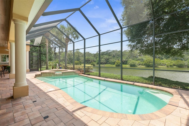 view of pool with glass enclosure, a patio area, and an in ground hot tub