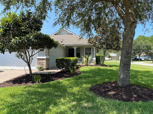 view of front of property featuring decorative driveway, stucco siding, a shingled roof, a garage, and a front lawn