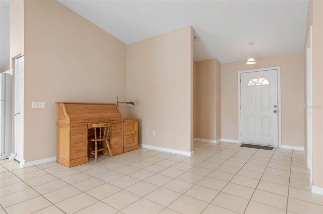 entrance foyer featuring lofted ceiling and light tile patterned floors