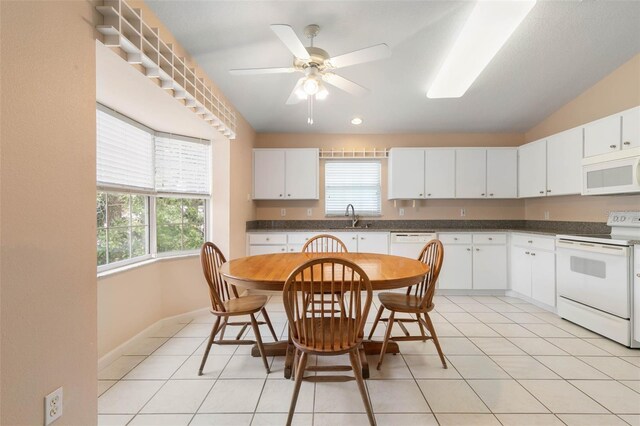 kitchen featuring white cabinetry, white appliances, and light tile patterned floors