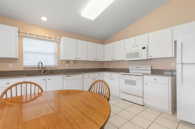 kitchen with white cabinets, vaulted ceiling, and white appliances