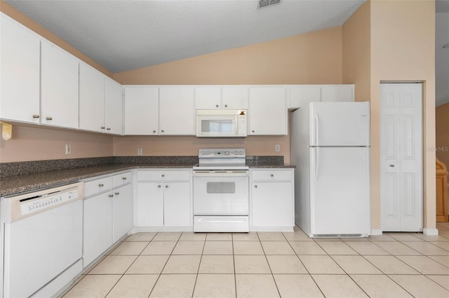 kitchen featuring white cabinetry, vaulted ceiling, white appliances, and light tile patterned floors