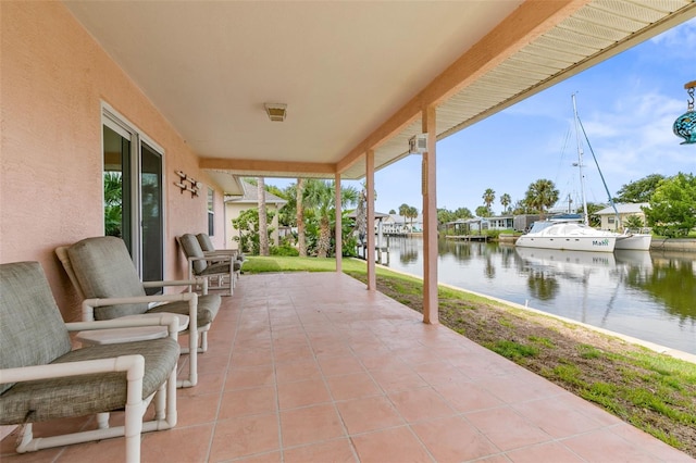 view of patio featuring a water view and a boat dock