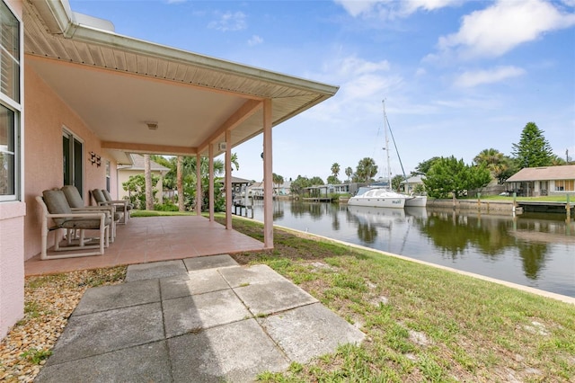 view of patio / terrace with a dock and a water view