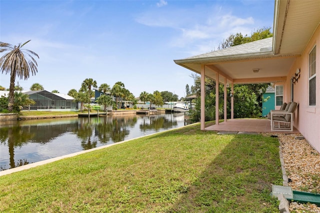 exterior space featuring a dock, a lanai, a water view, and a patio