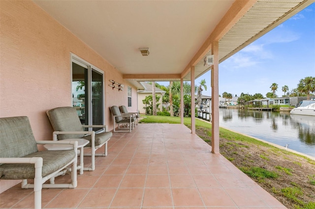 view of patio / terrace featuring a boat dock and a water view