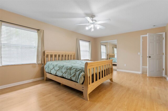 bedroom with a closet, ceiling fan, and light wood-type flooring