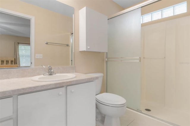 bathroom with vanity, toilet, tile patterned floors, and a shower with door