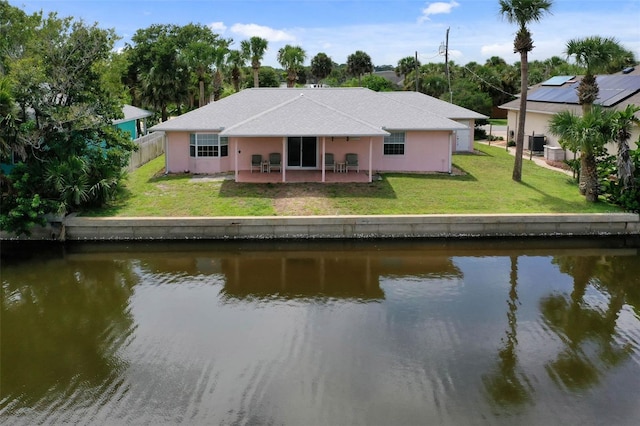 exterior space with a patio, a water view, and a yard