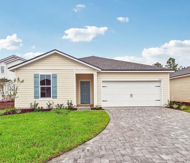 ranch-style house featuring a garage and a front yard