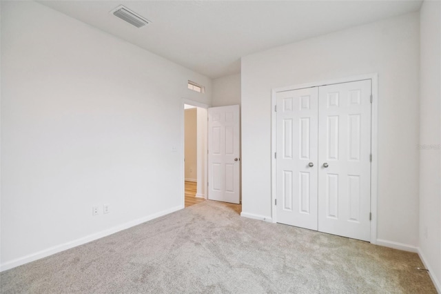 unfurnished bedroom featuring a closet and carpet