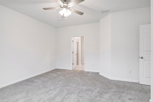 carpeted spare room with ceiling fan