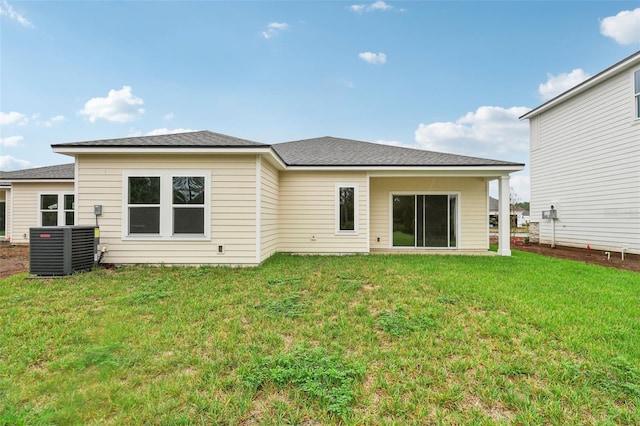 back of property featuring a yard and central AC unit