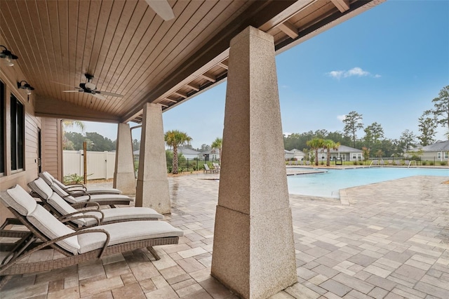 view of patio / terrace with a fenced in pool and ceiling fan