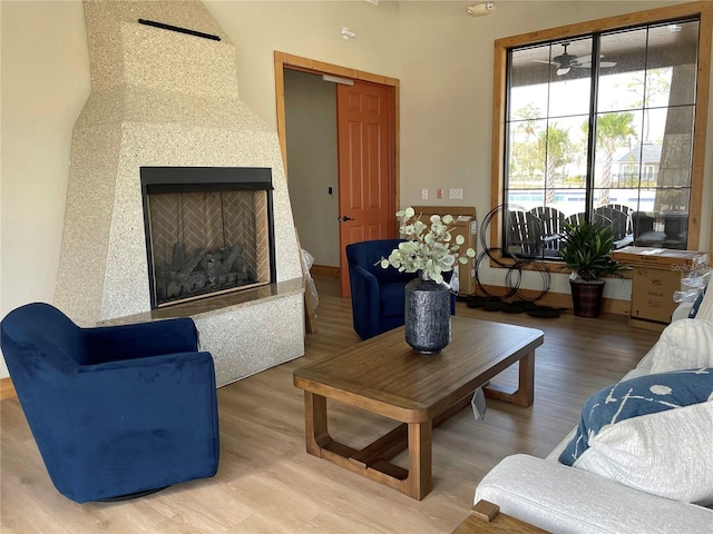 living room featuring ceiling fan and hardwood / wood-style floors