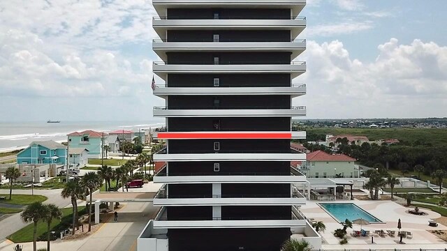 view of building exterior featuring a community pool