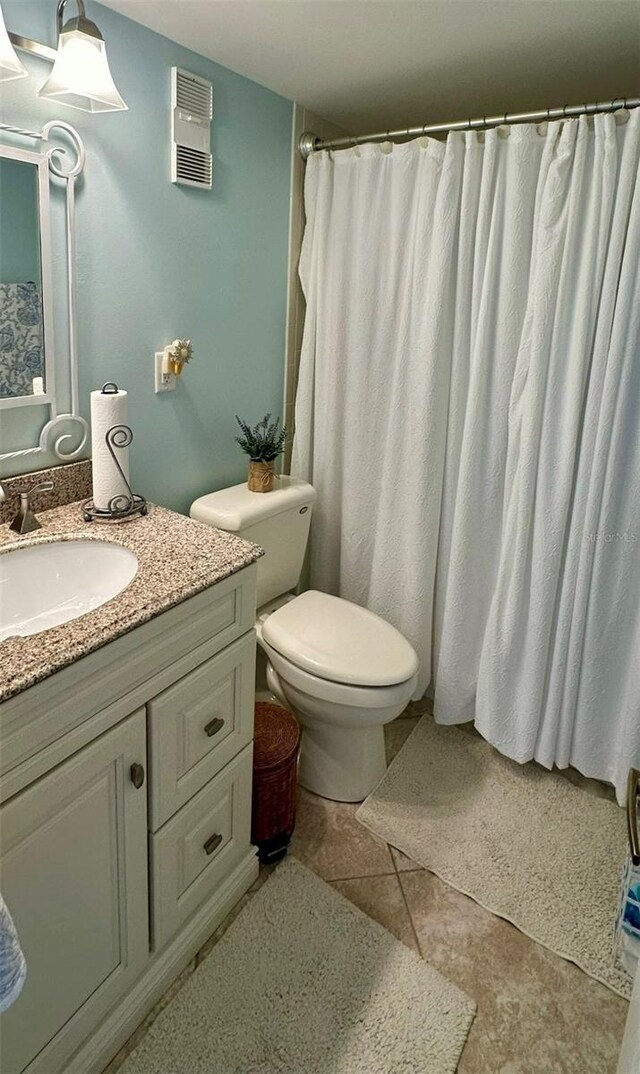 bathroom with tile patterned floors, vanity, and toilet