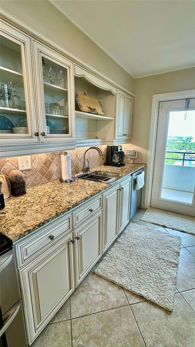 kitchen featuring stone counters, stainless steel dishwasher, light tile patterned floors, and decorative backsplash