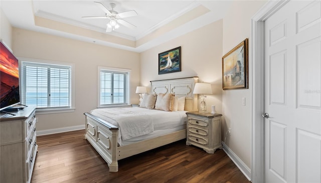 bedroom with ceiling fan, a raised ceiling, ornamental molding, and dark hardwood / wood-style floors