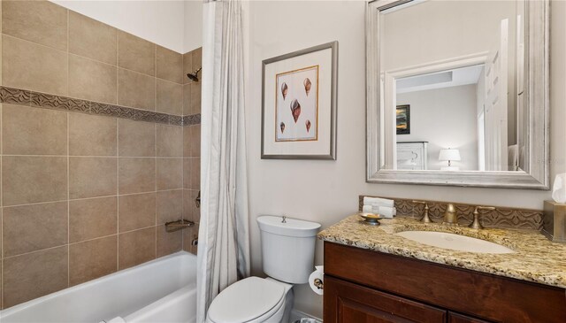 full bathroom with vanity, shower / tub combo, and toilet