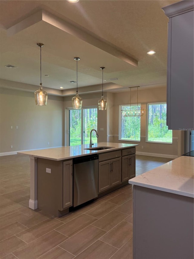 201 Hawthorn Ave, Palm Coast, FL 32164 - kitchen featuring stainless steel dishwasher, a sink, baseboards, healthy amount of natural light, and recessed lighting