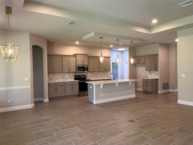 201 Hawthorn Ave, Palm Coast, FL 32164 - kitchen with stainless steel appliances, tasteful backsplash, wood finished floors, a sink, and recessed lighting