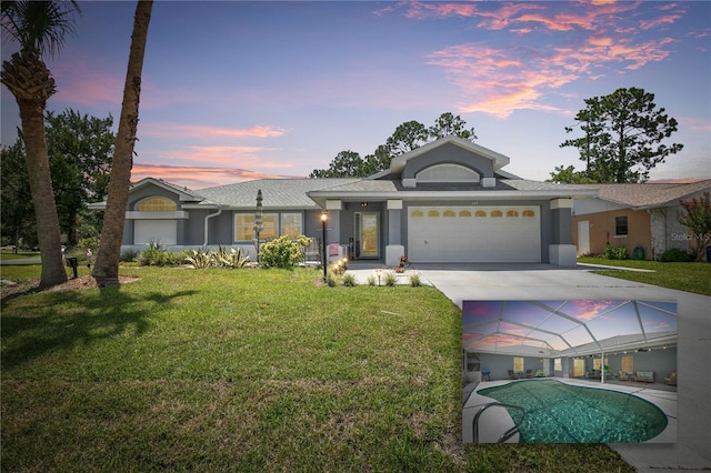 view of front facade featuring a garage and a lawn