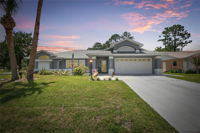 view of front of property with a lawn and a garage