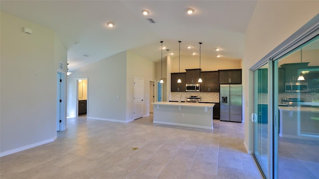 kitchen featuring high vaulted ceiling, stainless steel appliances, an island with sink, decorative backsplash, and decorative light fixtures