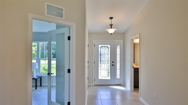 tiled foyer with lofted ceiling and a wealth of natural light