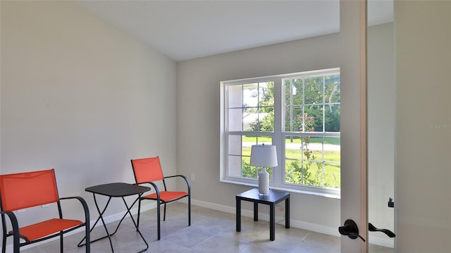 sitting room with light tile patterned floors and a wealth of natural light