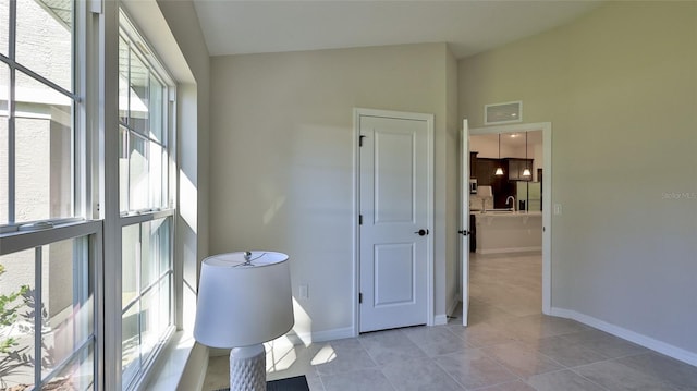 bathroom with tile patterned flooring and vaulted ceiling