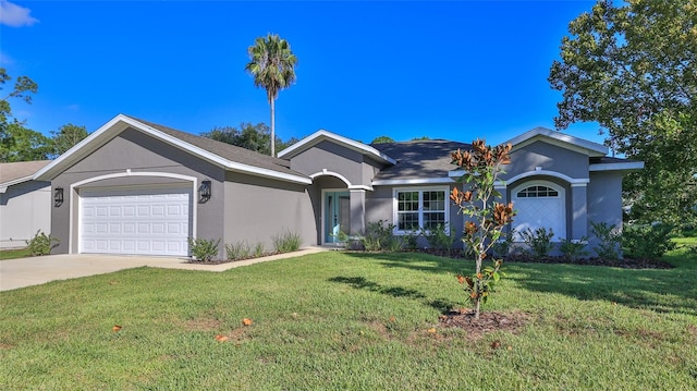 single story home with a garage and a front lawn