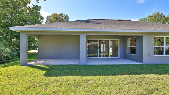 rear view of house featuring a patio and a lawn