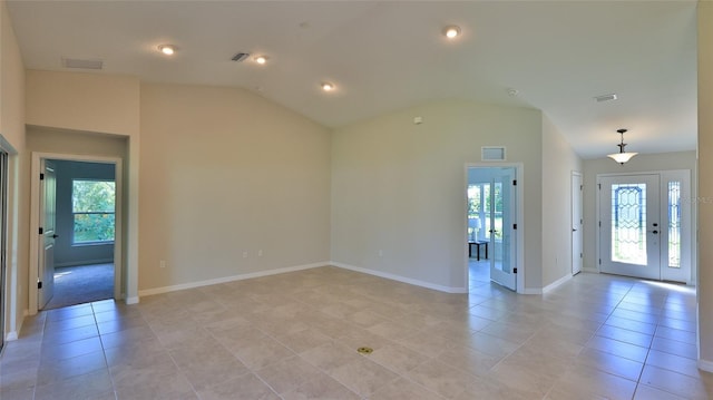 interior space featuring vaulted ceiling, a wealth of natural light, and light tile patterned flooring