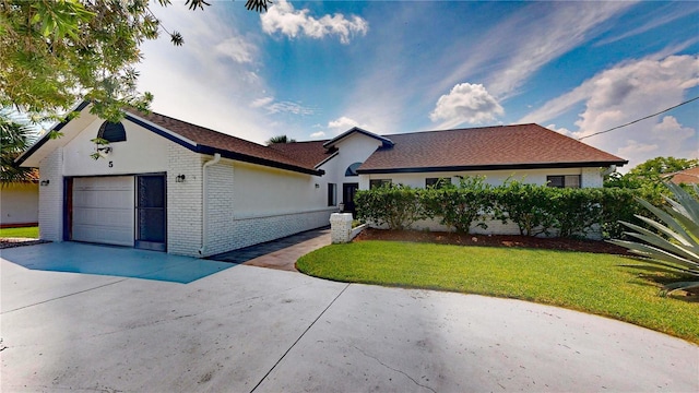 single story home with a garage and a front yard