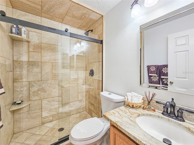 bathroom featuring vanity, toilet, and an enclosed shower