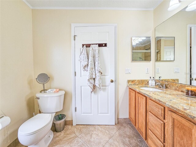 bathroom featuring crown molding, tile patterned floors, vanity, and toilet