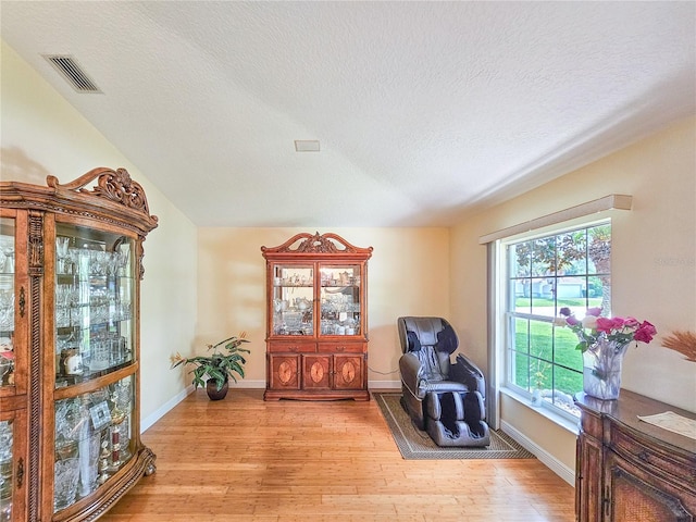 sitting room with light hardwood / wood-style flooring and a textured ceiling