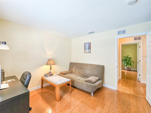 interior space featuring hardwood / wood-style floors and a textured ceiling